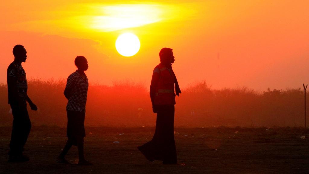 South Sudanese walking at sunset in northern Uganda - December 2016