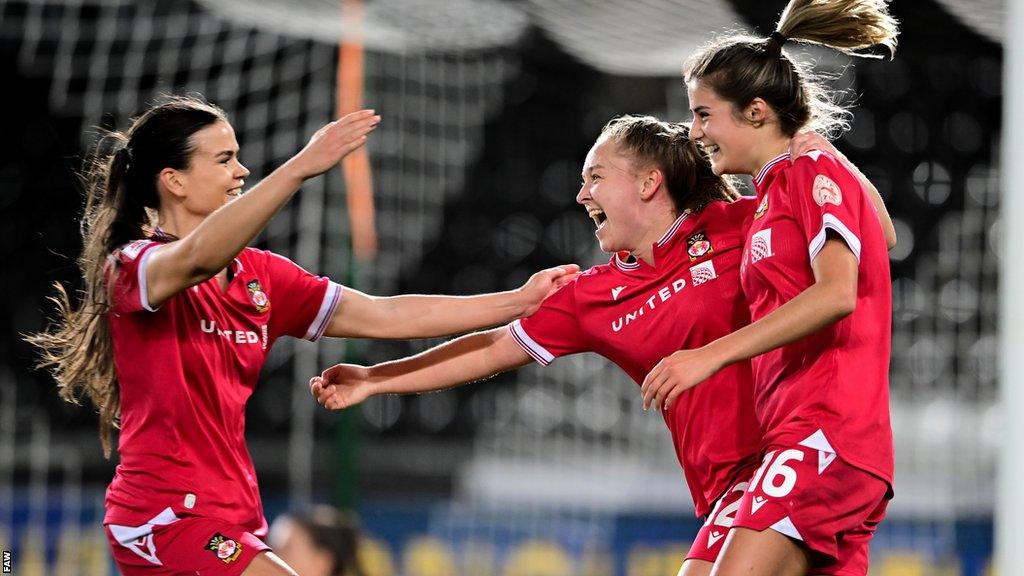 Wrexham players celebrate after Carra Jones' tap-in put them in front