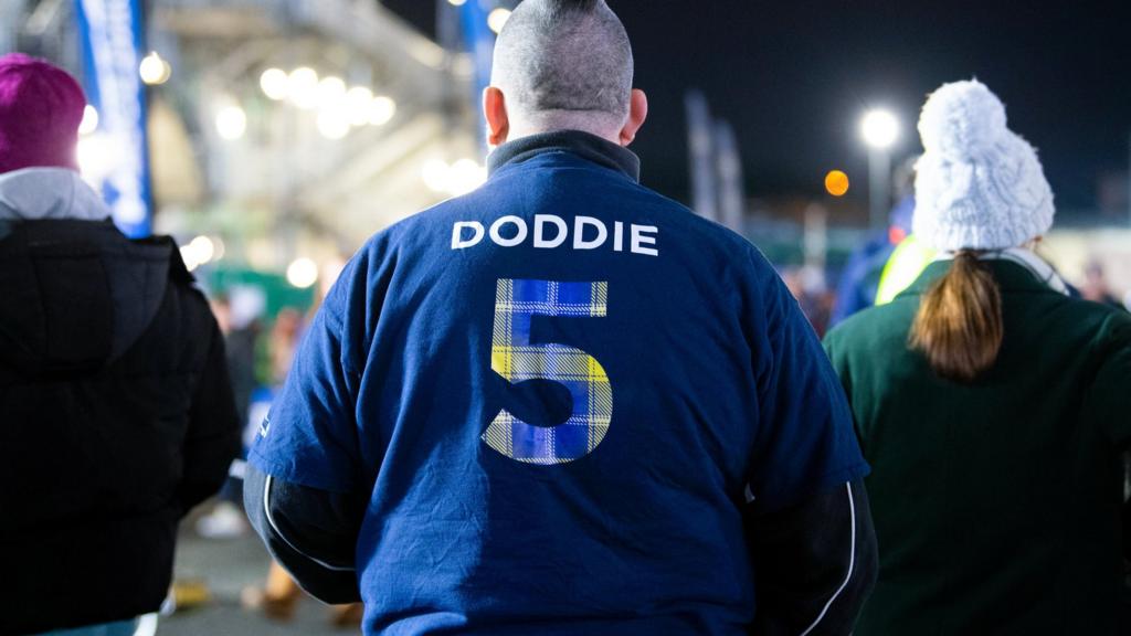 A fan wearing a top dedicated to Doddie Weir during a BKT United Rugby Championship match between Edinburgh Rugby and Munster at the DAM Health Stadium