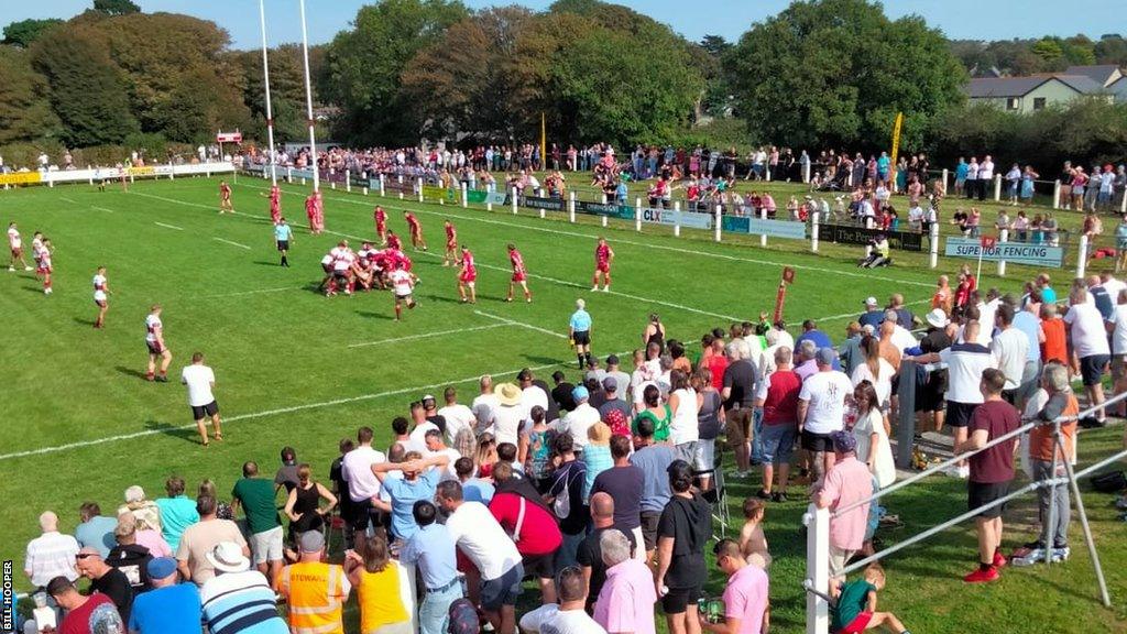 A shot of Camborne playing Redruth with a large crowd looking on