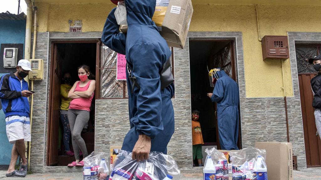 Residents receive humanitarian aid at their homes in the neighbourhood of Ciudad Bolivar on July 13, 2020 in Bogota, Colombia.