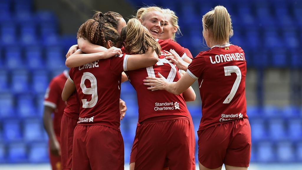 Women footballers celebrating