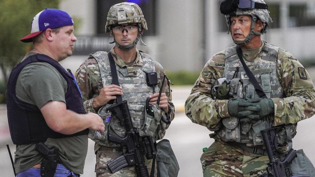 National Guard personnel talking to police officer in Kenosha