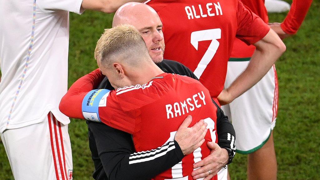 Wales manager Rob Page consoles midfielder Aaron Ramsey after their World Cup exit