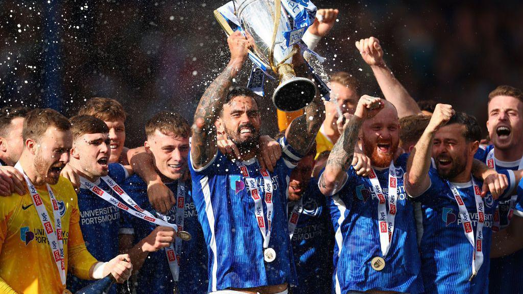 Portsmouth players celebrate winning the League One title