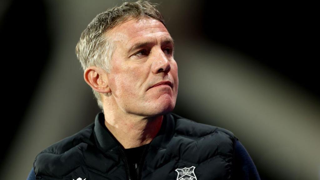 Wrexham manager Phil Parkinson looks up from the technical area