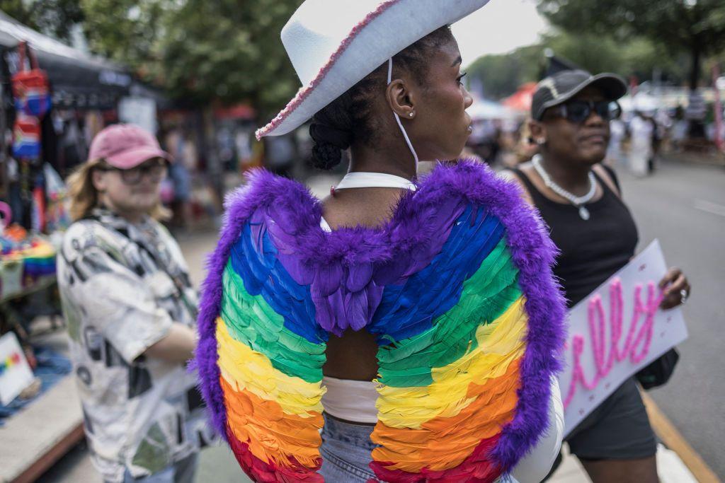 An attendee parades an outfit adorned with rainbow-colored wings during the 2024 edition of the Johannesburg Pride.