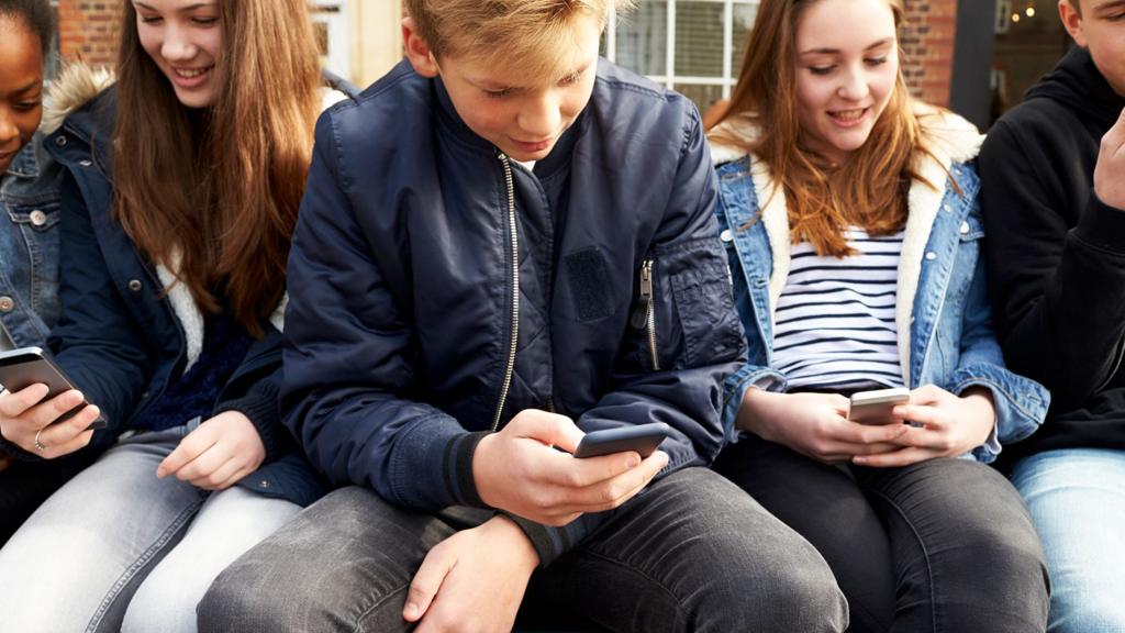 Kids on phones (stock image)