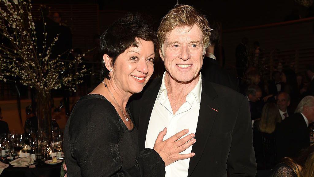 Robert Redford and his second wife, Sibylle Szaggars, in 2015. They are in an informal pose for the cameras and smiling.