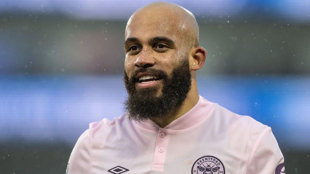 Bryan Mbeumo smiles while playing for Brentford