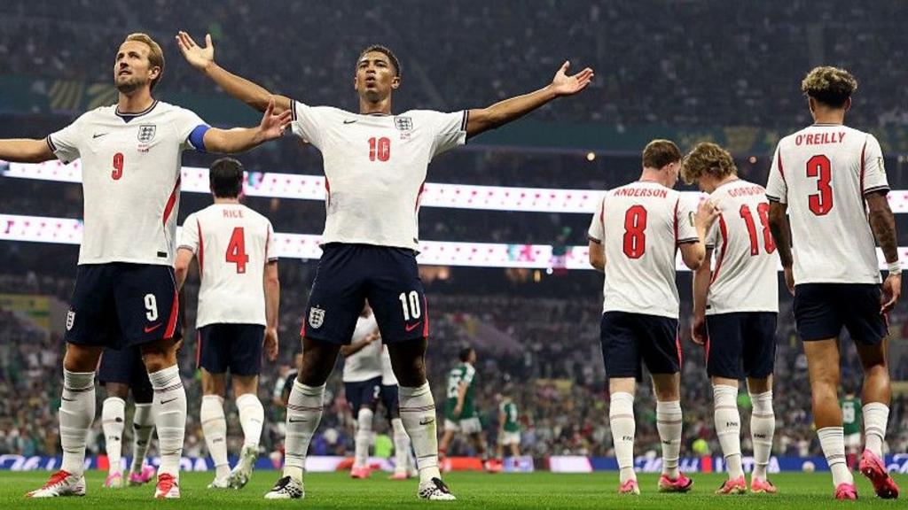 England captain Harry Kane and midfielder Jude Bellingham celebrate after scoring against Mexico with their teammates in the background