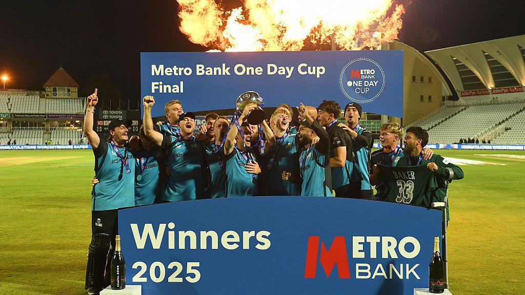 Worcestershire's squad celebrate winning the One-Day Cup with fireworks going off in the background