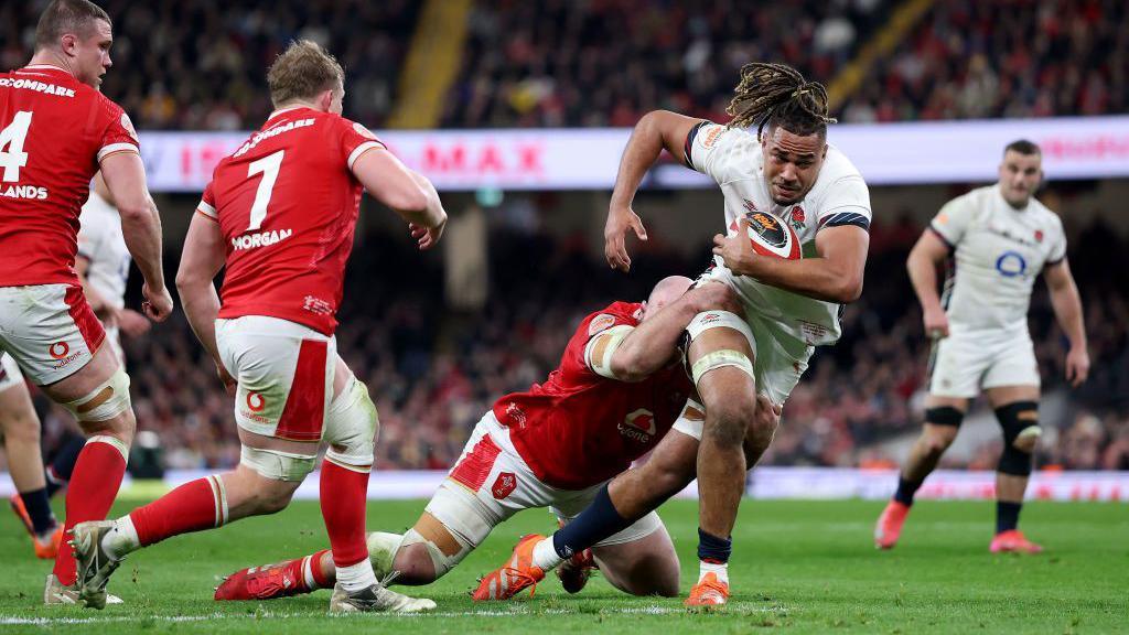 Chandler Cunningham-South carries the ball against Wales