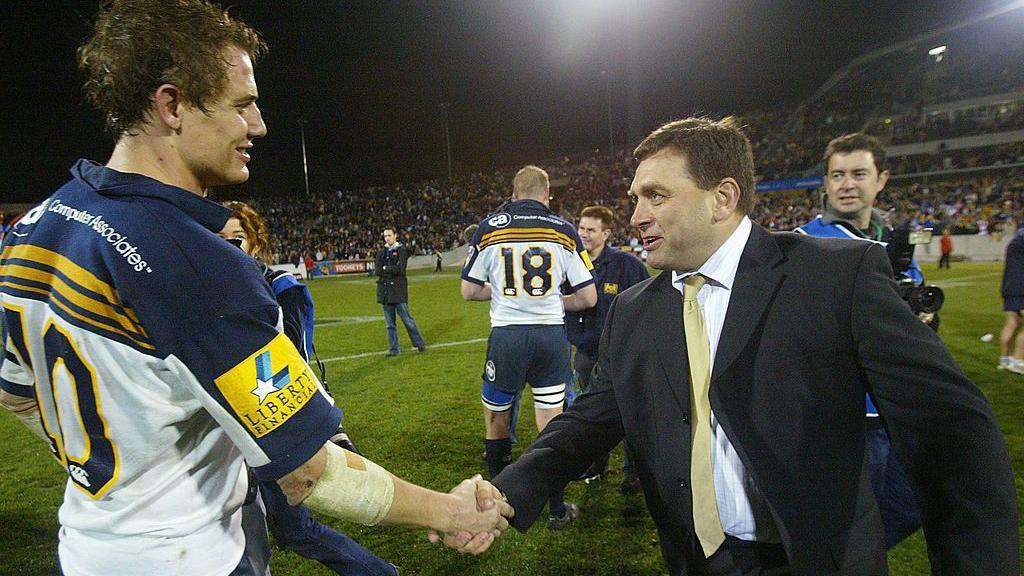 David Nucifora shakes hands with Stephen Larkham