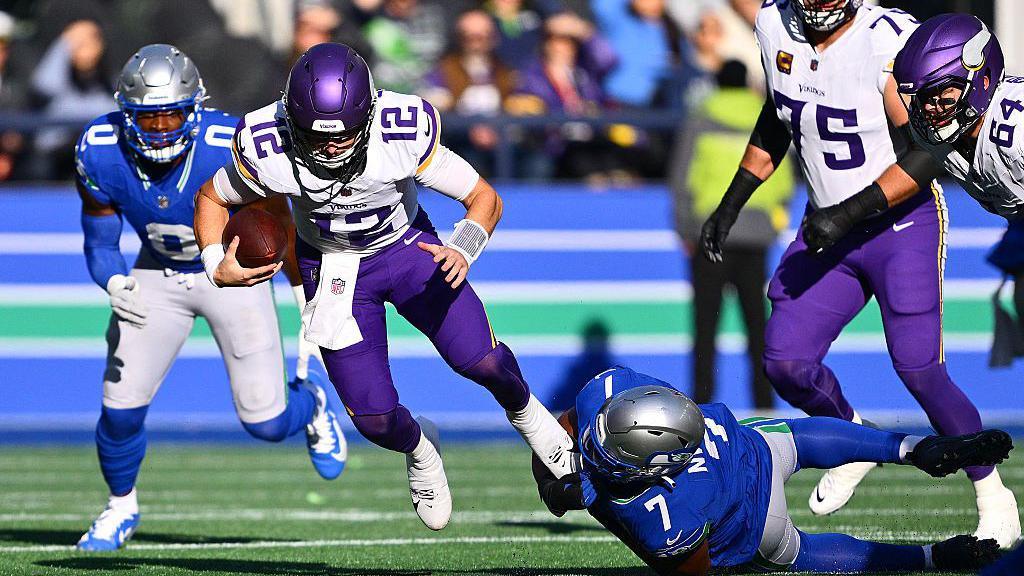Minnesota Vikings quarterback Max Brosmer gets tackled by the Seattle Seahawks defence during their game in the NFL