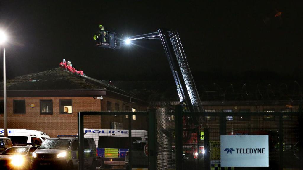 Protesters on roof of Teledyne building