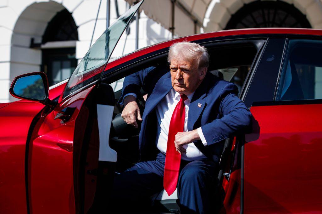 US President Donald Trump exits a Tesla Model S vehicle on the South Lawn of the White House in Washington