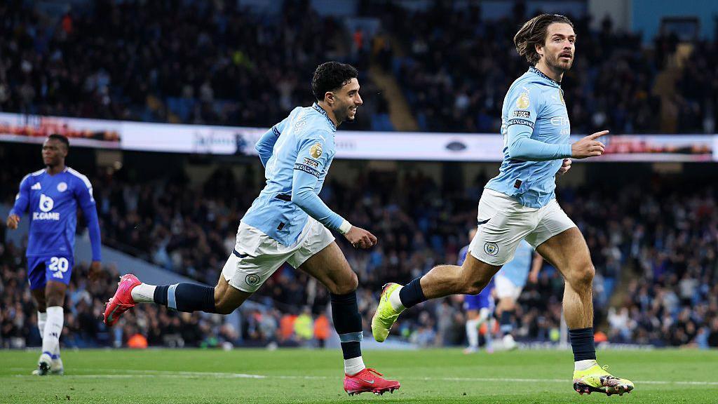 Jack Grealish (right) celebrates scoring against Leicester