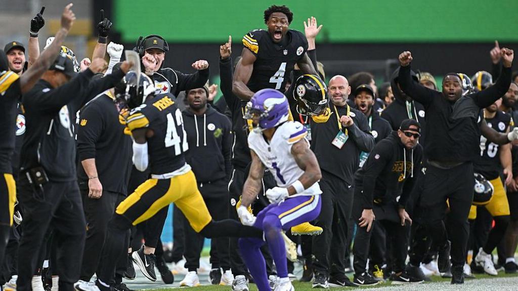 DK Metcalf celebrates as Pittsburgh Steelers team-mate James Pierre makes an interception against the Minnesota Vikings but the play was reversed