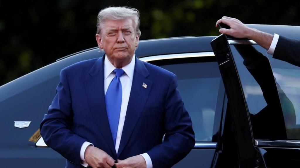 U.S. President Donald Trump steps out of a car as he arrives at the Nato summit in The Hague