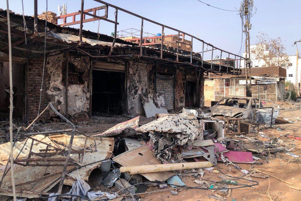 Heavily damaged shops in Omdurman, which are totally burnt out, piles of damaged debris out the front and also a burnt out car on May 30, 2024.