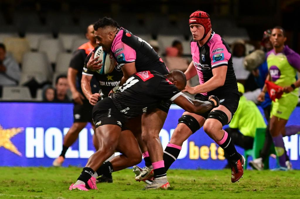Willis Halaholo of Cardiff Rugby is tackled by Aphiwe Dyantyi of Sharks as James Botham comes up in support