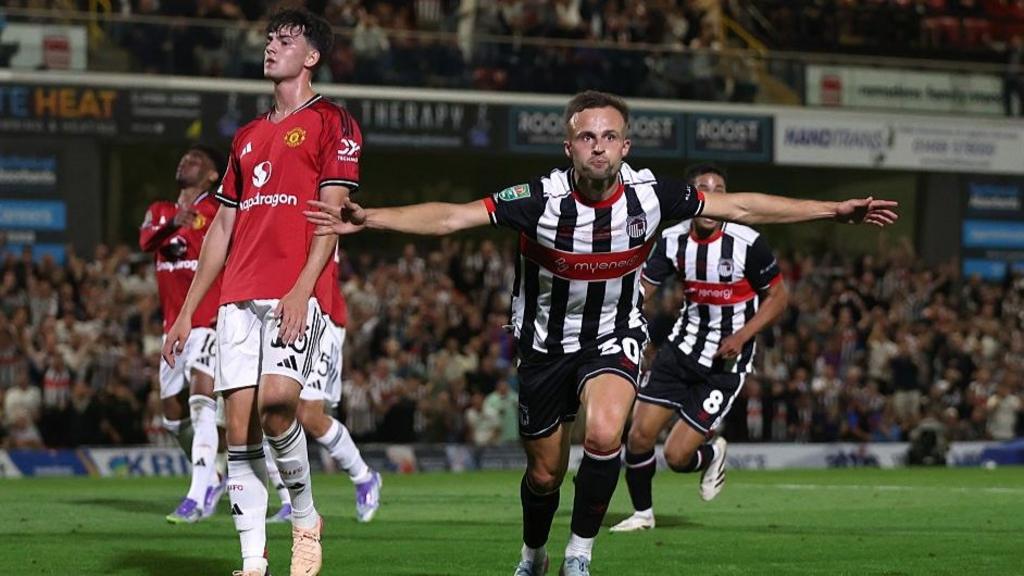 Grimsby celebrate a famous win over Man Utd