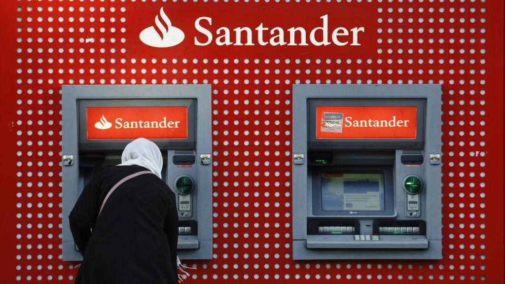 Santander customer taking money out of a cash machine