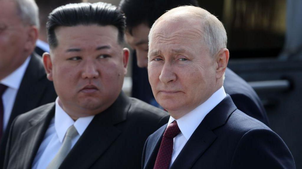Close up photo of North Korean leader Kim Jong Un and Russian leader Vladimir Putin standing side by side