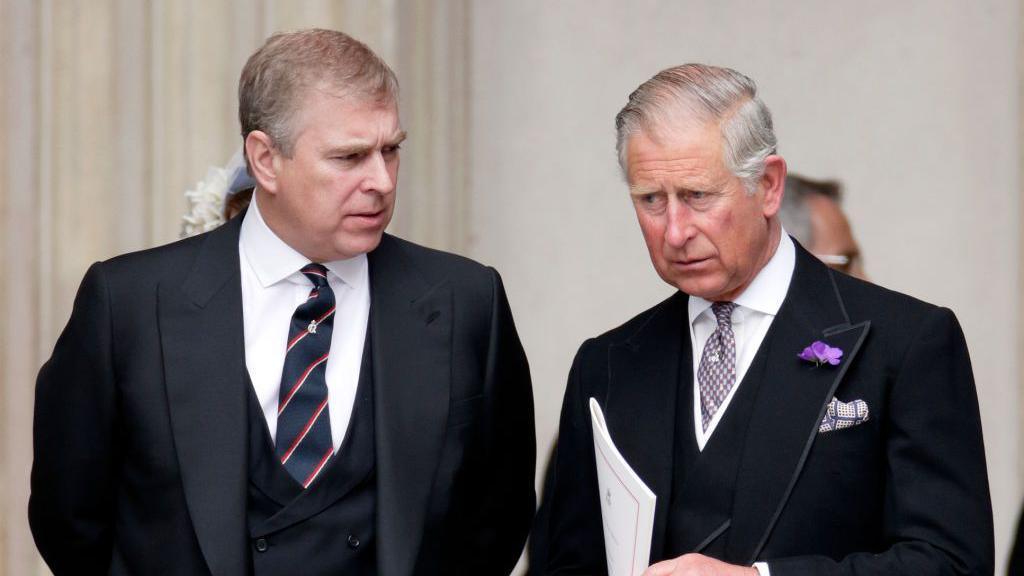 Prince Andrew and the King in suits at St Paul's Cathedral in 2012 - They are both wearing suits with waistcoats, are leaning slightly towards each other, and appear to be having a serious conversation 