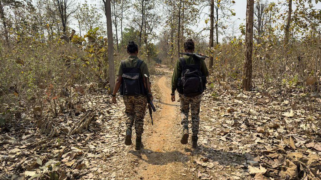 This photograph taken on March 16, 2025, shows District Reserve Guard (DRG) personnel Sanjana Yadav (R) and Anjila Minj patrolling during a simulation exercise at their base in Dantewada, in Bastar division of India's Chhattisgarh state. India is waging an all-out offensive against the last vestiges of its Naxalite rebellion, so named for the village where the Maoist-inspired guerrilla movement began nearly 60 years ago. Since the start of last year, security forces have killed a record toll of nearly 400 suspected rebels. (Photo by Jalees ANDRABI / AFP) / TO GO WITH 'India-Maoist-Rights-Mining' SPECIAL REPORT by Arunabh SAIKIA (Photo by JALEES ANDRABI/AFP via Getty Images)