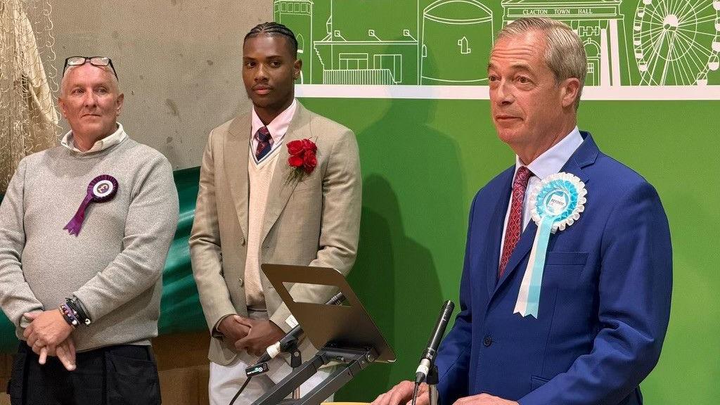 Jovan Owusu-Nepaul on stage on election night next to Nigel Farage