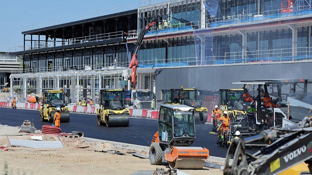 Workers finishing the tarmac in front of the pit lane of Madrid's brand-new Formula 1 circuit.