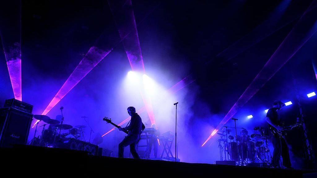 Faithless perform shrouded in purple light on day two of the Big Feastival.