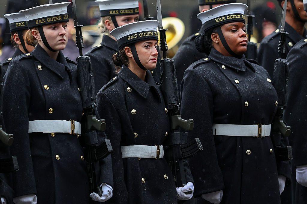 Royal Navy personnel on the Royal Mile - the front row is three young women wearing caps embroidered with the words "HMS Queen Elizabeth" in gold.
