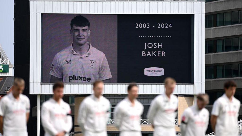 Players stand for a minute's silence in memory of Worcestershire spinner Josh Baker at Trent Bridge cricket ground.