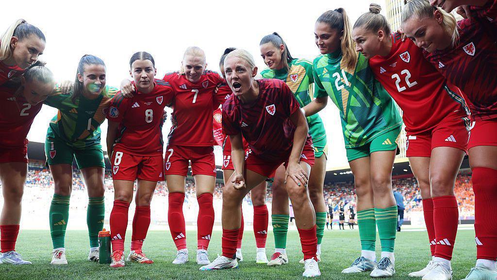 Wales players having a team talk.