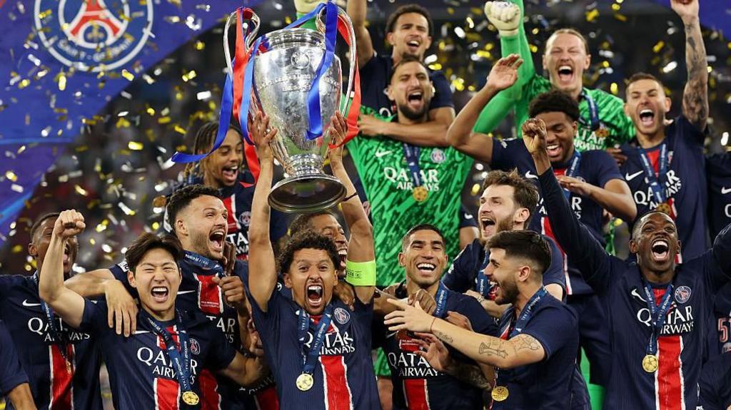 PSG players celebrate lifting the Champions League trophy