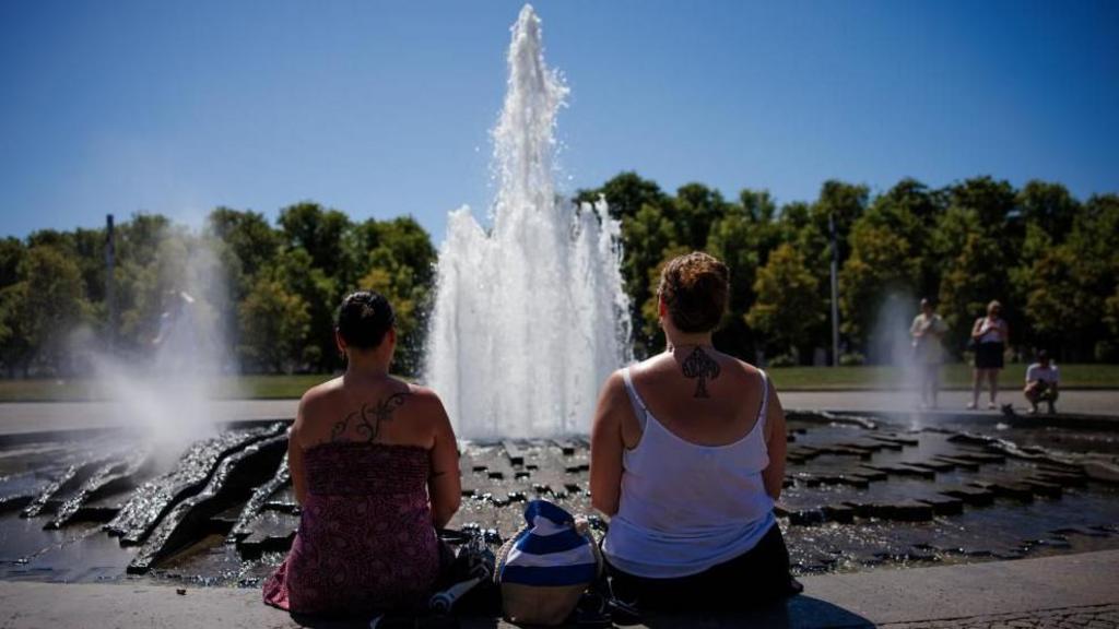 People trying to stay cool during Europe's record-breaking heatwave