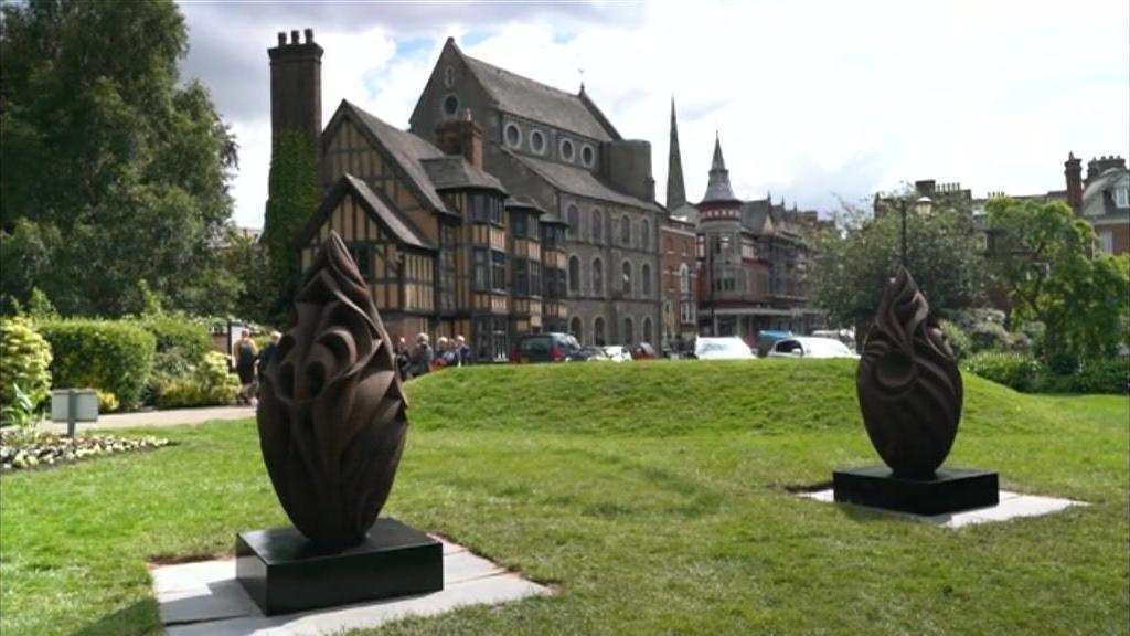 Two tear-shaped iron sculptures on the grass in front of Shrewsbury Castle