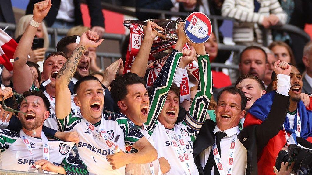 Sunderland's Dan Neil lifts the Championship play-offs trophy and celebrates promotion