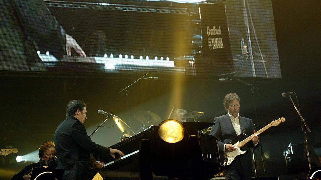 Jools Holand and Eric Clapton performs on stage at the "Tsunami Disaster Fundraising Concert" at the Millennium Stadium on January 22, 2005 in Cardiff, Wales.