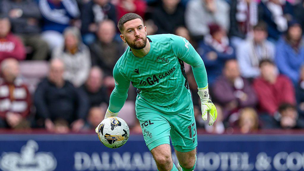 Motherwell goalkeeper Calum Ward rolls the ball out during the Premier League match between Heart of Midlothian and Motherwell at Tynecastle Park on April 11, 2026 in Edinburgh, Scotland. 