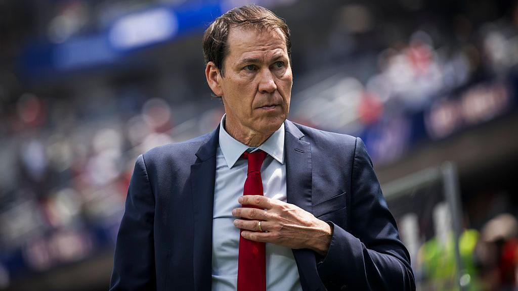 Rudi Garcia holds his tie during the 2026 World Cup