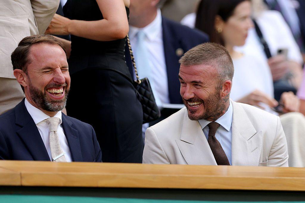 Sir Gareth Southgate and Sir David Beckham laugh together while sat in the Royal Box at Wimbledon's Centre Court on the opening day of the 2025 Championships