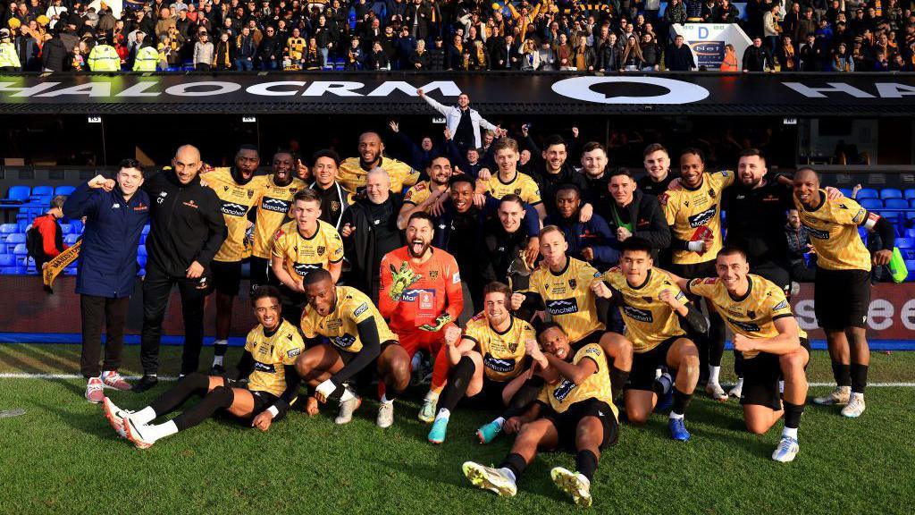 Maidstone United's squad celebrate their win over Ipswich