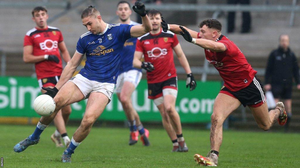 Down's Pierce Laverty attempts to block a Killian Clarke kick in the 2020 Ulster Football semi-final at the Athletic Grounds