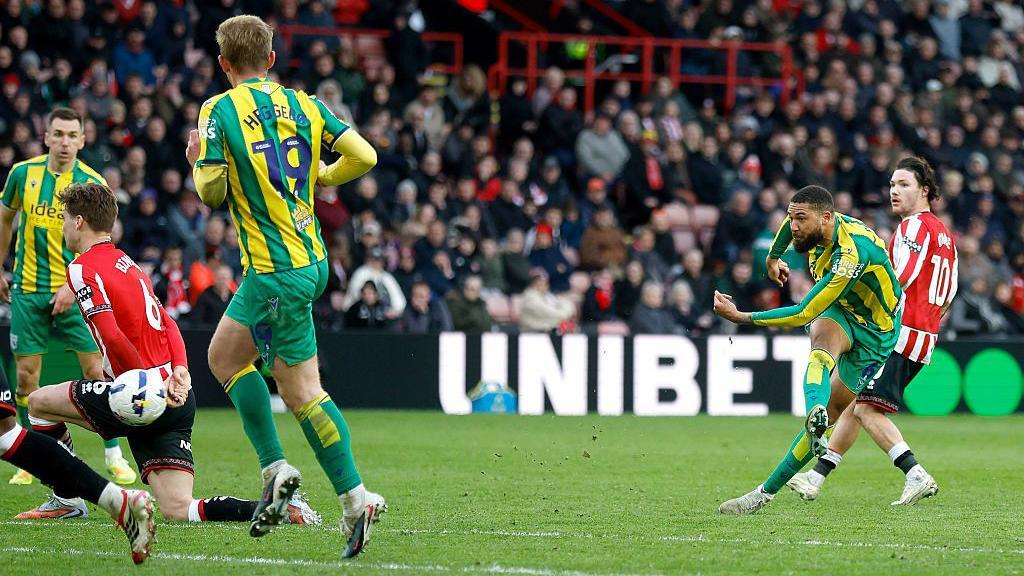 George Campbell strikes the ball towards goal.