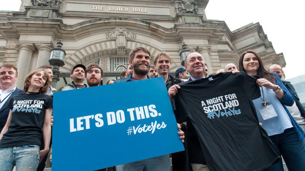 EDINBURGH, UNITED KINGDOM - SEPTEMBER 14: Alex Salmond makes a selfie with a fan during a photocall to present the event A Night For Scotland, a concert for 'Yes Scotland' Referendum campaign at Usher Hall on September 14, 2014 in Edinburgh,