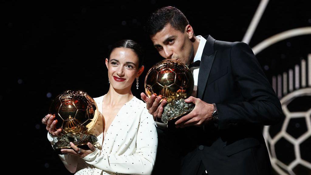 Rodri and Aitana Bonmati holding their awards.